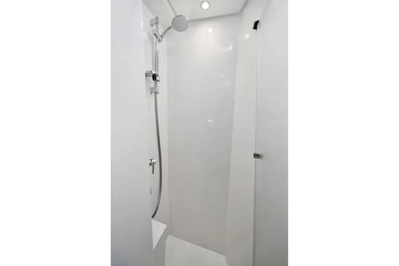 Slide: The Image of 2019 Itacatamarans 14.99 sailboat with "Navitas" branding, docked near a marina. - 153