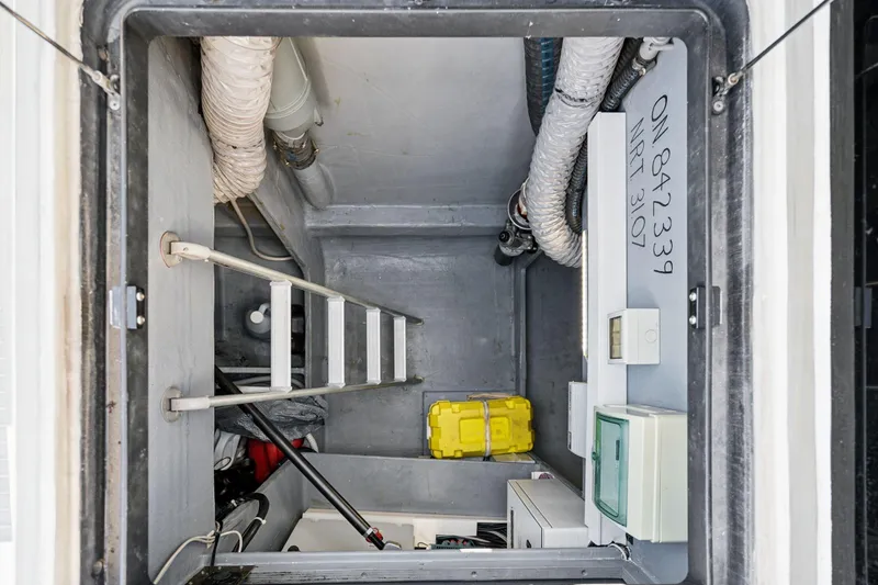 Slide: The Image of Engine room of a 2019 Itacatamarans 14.99, showcasing mechanical components and wiring. - 164