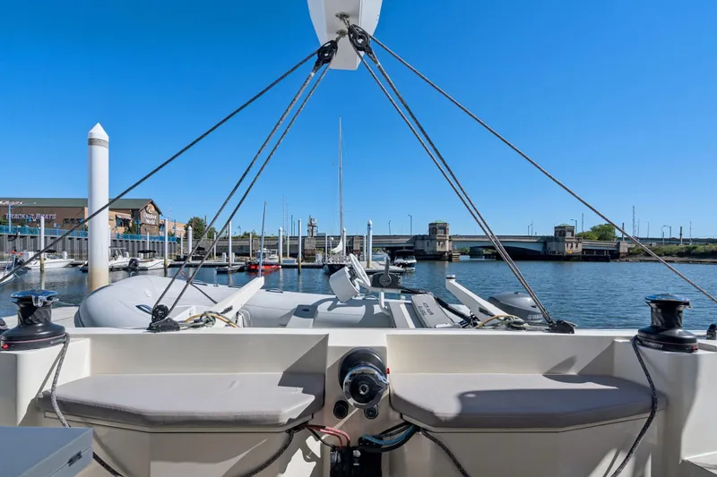 Slide: The Image of Helm of 2019 Itacatamarans 14.99 catamaran with steering wheel and controls, on calm water. - 21