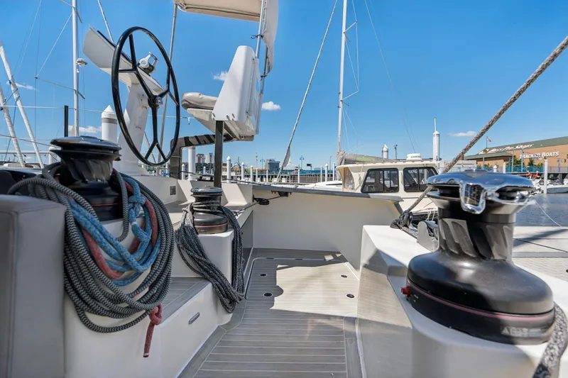 Slide: The Image of 2019 Itacatamarans 14.99 yacht cockpit with seating, steering wheel, and water view. - 23