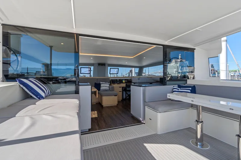 Slide: The Image of Luxurious 2019 Itacatamarans 14.99 yacht interior with marina view and modern seating area. - 30