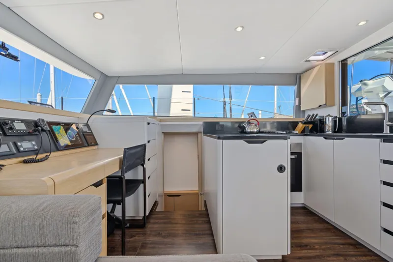 Slide: The Image of 2019 Itacatamarans 14.99 yacht cockpit with steering wheel and ropes, docked at marina. - 36