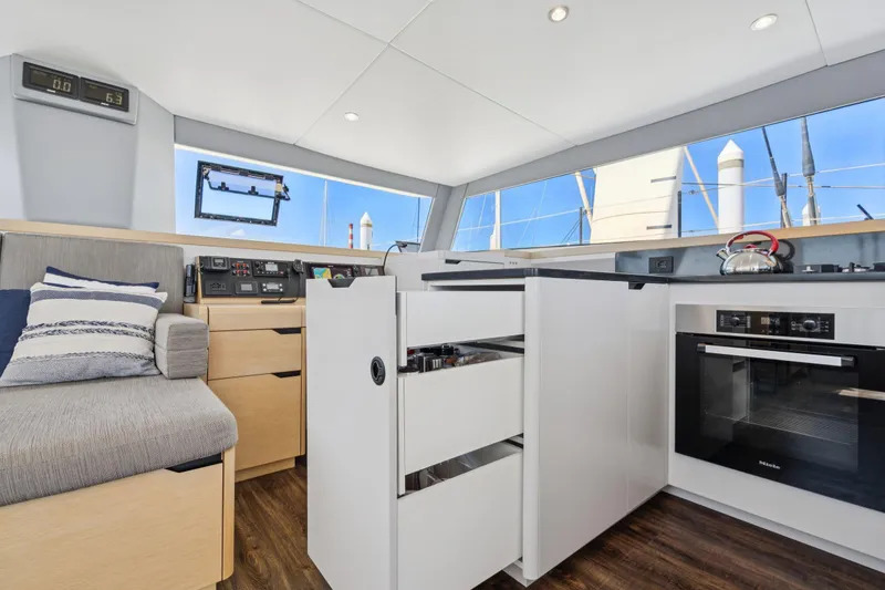 Slide: The Image of 2019 Itacatamarans 14.99 catamaran helm station with marina view. - 40