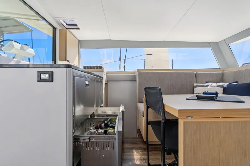 Slide: The Image of 2019 Itacatamarans 14.99 interior with seating, table, and panoramic windows. - 49