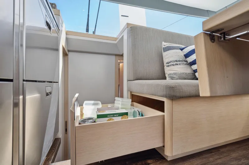 Slide: The Image of Laundry area with washing machine and shelves in 2019 Itacatamarans 14.99 model. - 94