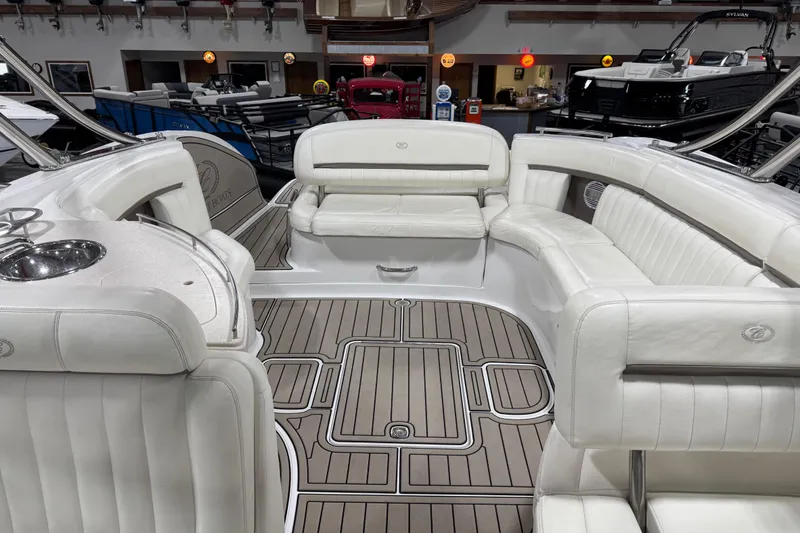 Slide: The Image of Luxurious interior of a 2007 Cobalt 323 boat with white seating and wood-patterned flooring. - 15