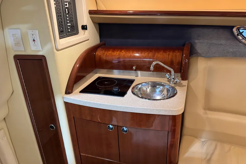 Slide: The Image of 2007 Cobalt 323 boat interior kitchenette with sink and stove. - 16