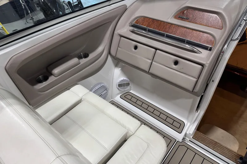 Slide: The Image of Interior of a 2007 Cobalt 323 boat with beige seating and storage compartments. - 19