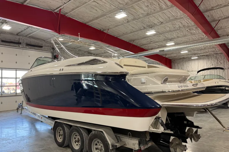 Slide: The Image of 2007 Cobalt 323 boat in a warehouse, on a trailer, with a sleek design. - 3