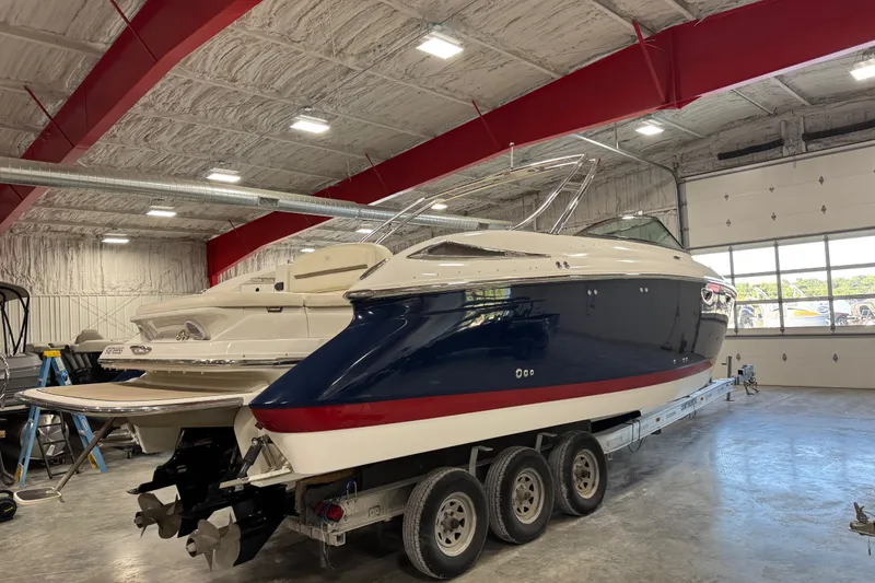 Slide: The Image of 2007 Cobalt 323 boat in a garage, featuring a sleek blue and white design. - 4