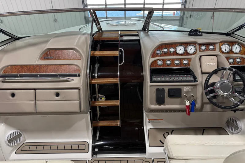 Slide: The Image of 2007 Cobalt 323 boat interior with wood accents, steering wheel, and control panel. - 7
