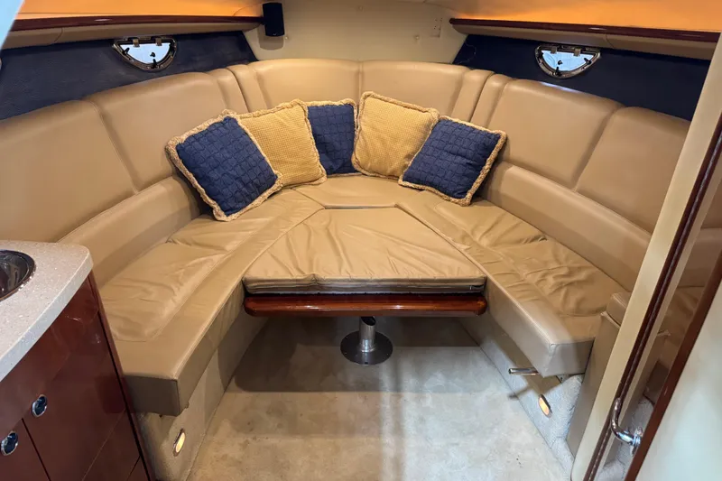 Slide: The Image of Luxurious 2007 Cobalt 323 boat interior with beige seating and decorative cushions. - 8