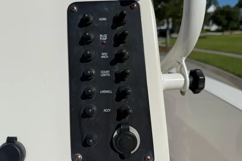 Slide: The Image of Control panel of a 2016 Robalo R160 Center Console boat with labeled switches. - 12