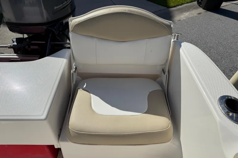 Slide: The Image of 2016 Robalo R160 Center Console boat seat with beige and white upholstery. - 15