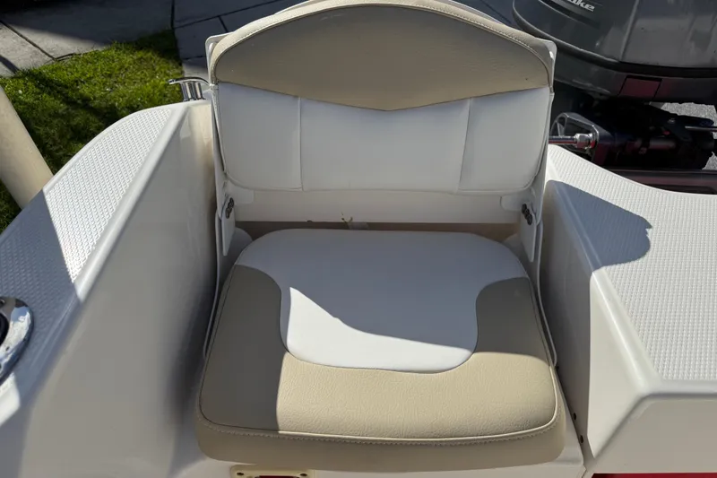 Slide: The Image of 2016 Robalo R160 Center Console boat seat with beige and white upholstery. - 16