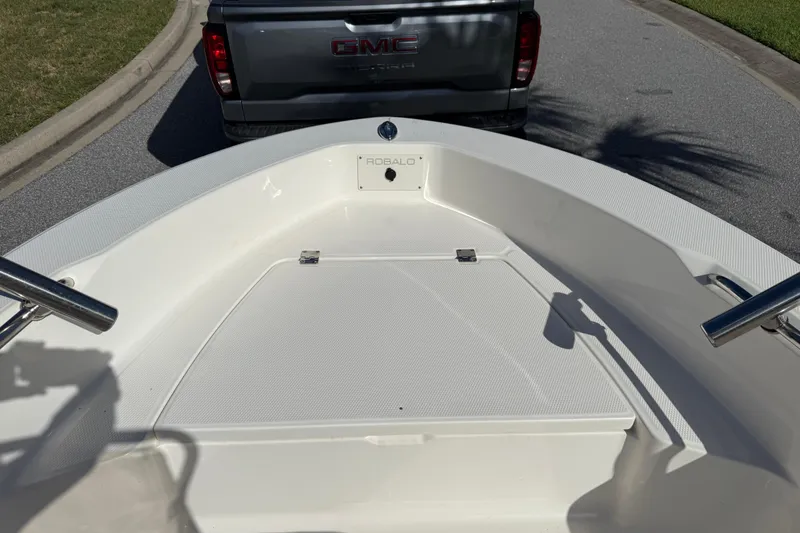 Slide: The Image of 2016 Robalo R160 Center Console boat on trailer, parked behind GMC truck. - 19