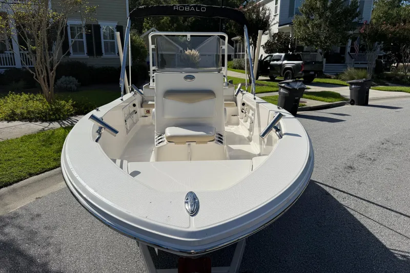 Slide: The Image of 2016 Robalo R160 Center Console boat parked on a residential street. - 4