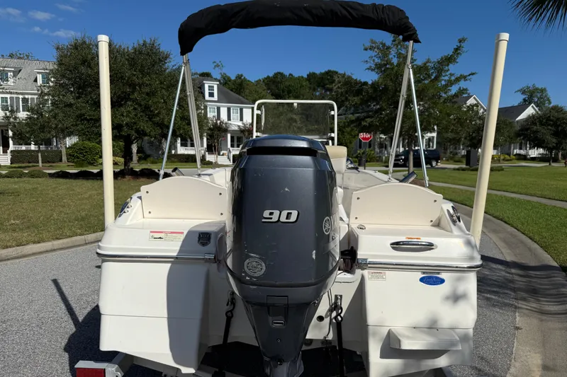 Slide: The Image of 2016 Robalo R160 Center Console boat with Yamaha 90 engine, parked in suburban neighborhood. - 5