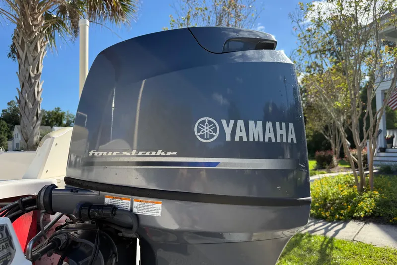 Slide: The Image of Yamaha four-stroke engine on 2016 Robalo R160 Center Console boat, outdoor setting. - 7