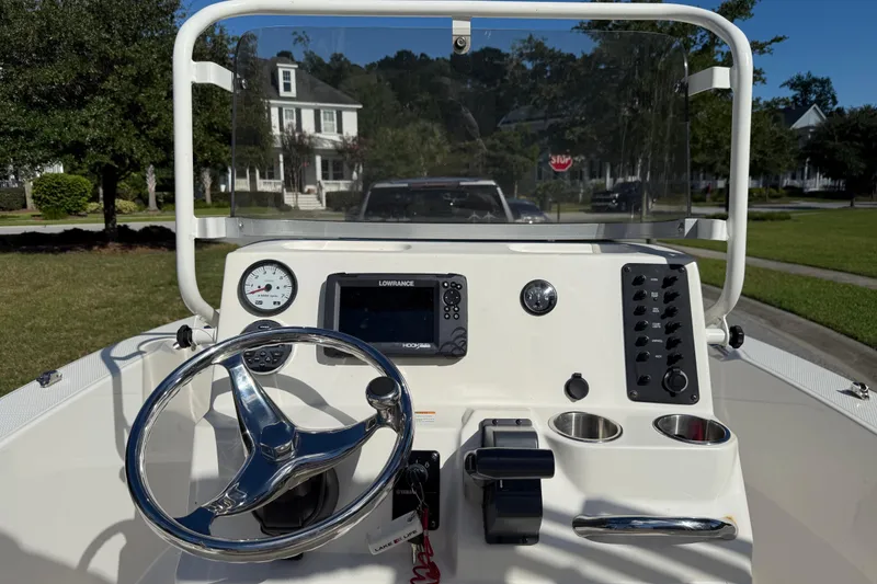 Slide: The Image of 2016 Robalo R160 Center Console boat dashboard with steering wheel and navigation equipment. - 8