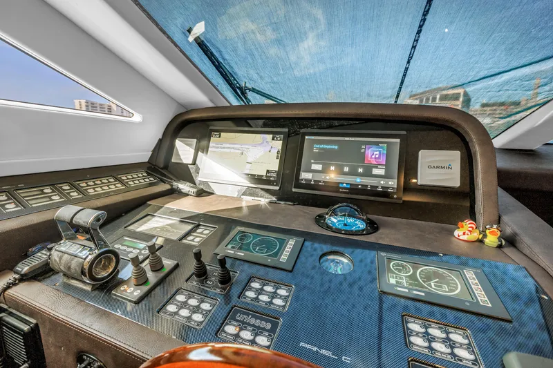 Slide: The Image of Control panel of 2009 Uniesse 65 MY yacht with navigation screens and instruments. - 17