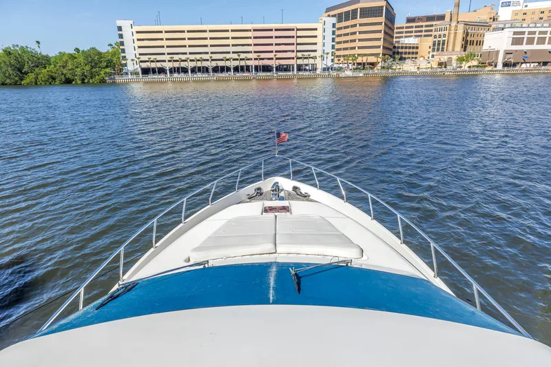 Slide: The Image of Bow view of 2009 Uniesse 65 MY yacht approaching urban waterfront. - 26