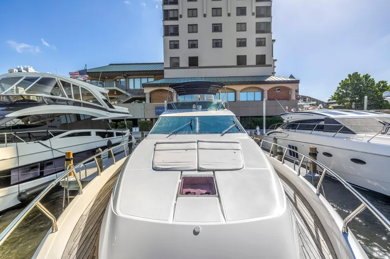 Slide: The Image of 2009 Uniesse 65 MY yacht docked at marina, surrounded by other luxury boats. - 35