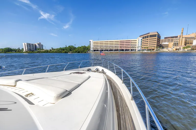 Slide: The Image of Bow view of 2009 Uniesse 65 MY yacht cruising near urban waterfront buildings. - 37