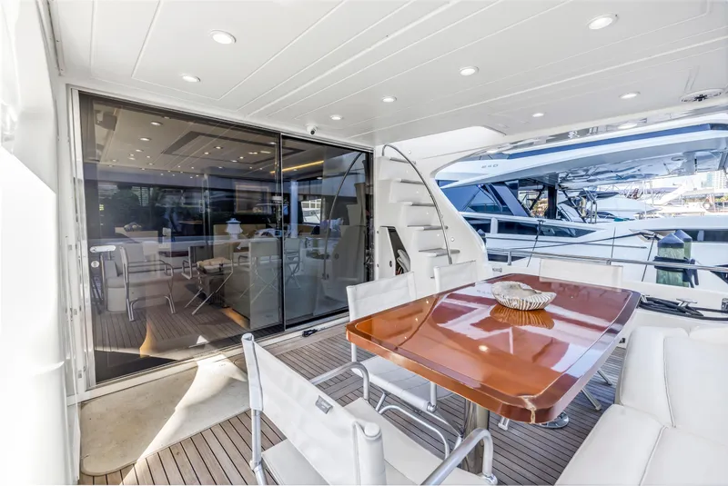 Slide: The Image of Luxurious 2009 Uniesse 65 MY yacht with elegant outdoor dining area and modern interior. - 40