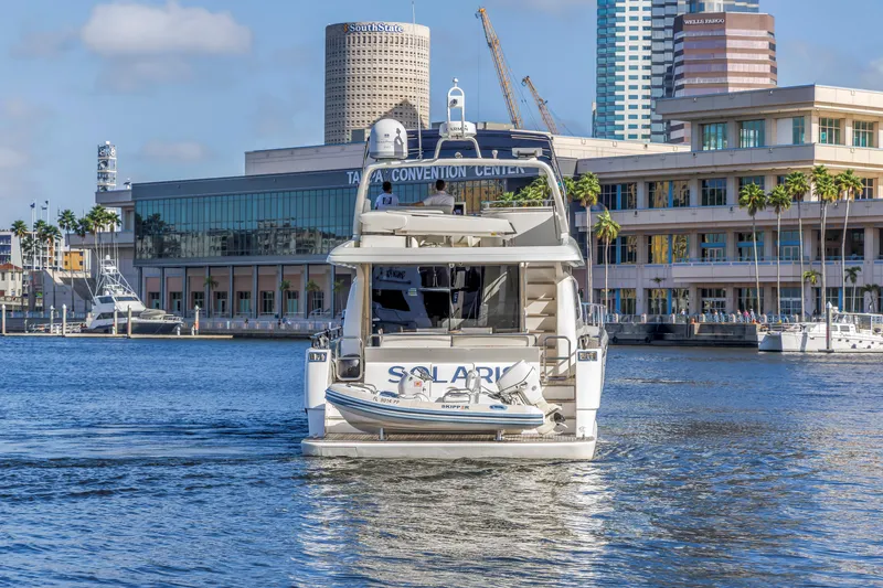 Slide: The Image of 2009 Uniesse 65 MY yacht in urban harbor, cityscape background. - 5