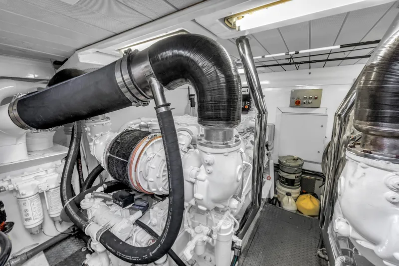 Slide: The Image of Engine room of 2009 Uniesse 65 MY yacht, showcasing mechanical components and systems. - 59