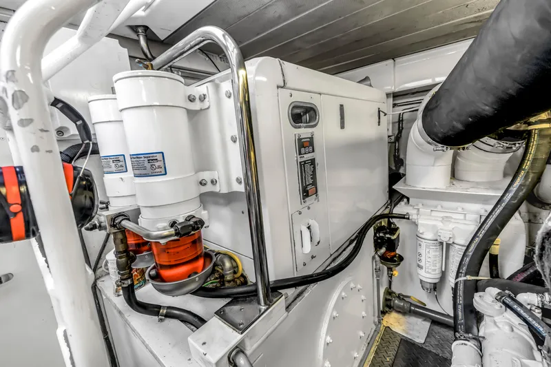 Slide: The Image of Engine room of 2009 Uniesse 65 MY yacht, showcasing mechanical components and systems. - 60