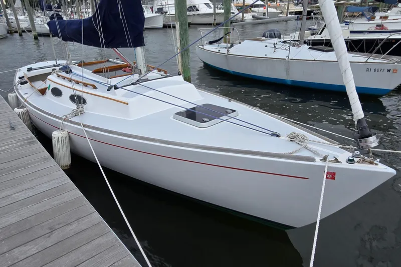 Slide: The Image of Sailboat docked at marina, Alerion 28 model, 1996, with sleek white hull and blue sail. - 2