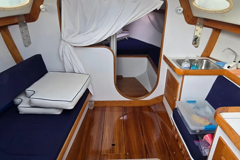 Slide: The Image of Interior of a 1996 Alerion 28 sailboat with wood accents and cozy seating. - 5