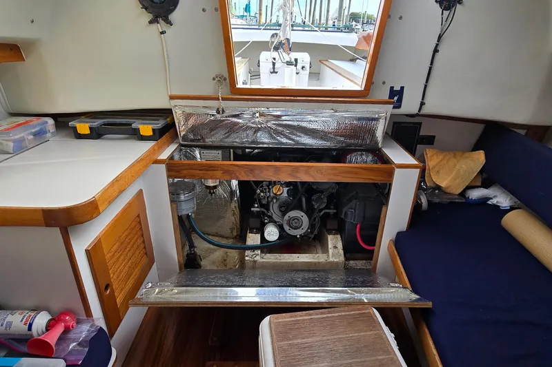 Slide: The Image of Engine compartment of a 1996 Alerion 28 sailboat, showcasing interior details and equipment. - 6