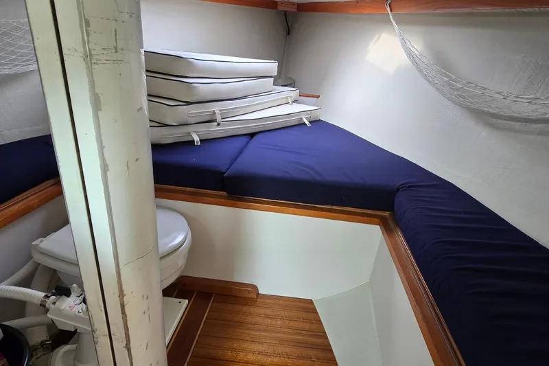 Slide: The Image of Interior of 1996 Alerion 28 sailboat with blue cushions and compact toilet. - 7