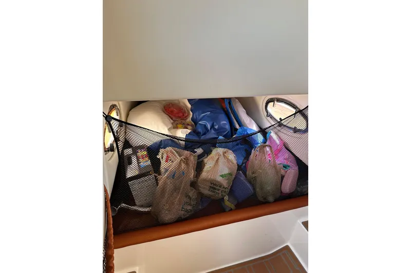 Slide: The Image of Interior storage area of 2015 Nor-Tech 390 Sport Center Console boat. - 10