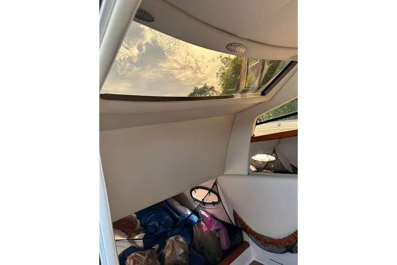 Slide: The Image of Interior view of 2015 Nor-Tech 390 Sport Center Console boat with skylight and storage area. - 11