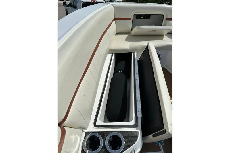 Slide: The Image of 2015 Nor-Tech 390 Sport Center Console interior with open storage compartments. - 12