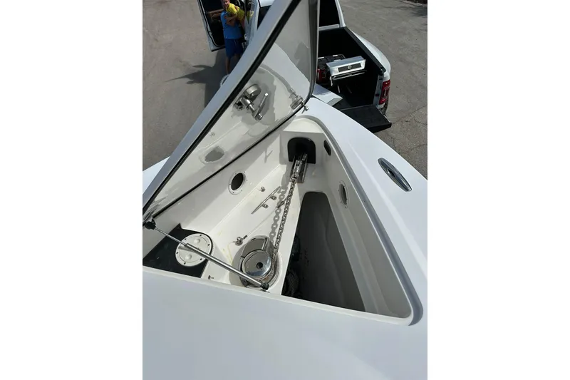 Slide: The Image of 2015 Nor-Tech 390 Sport Center Console anchor compartment, open lid, showing chain and mechanism. - 14