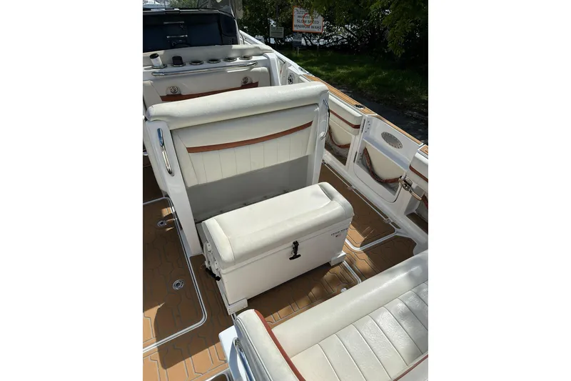 Slide: The Image of 2015 Nor-Tech 390 Sport Center Console interior with white seating and teak-style flooring. - 15