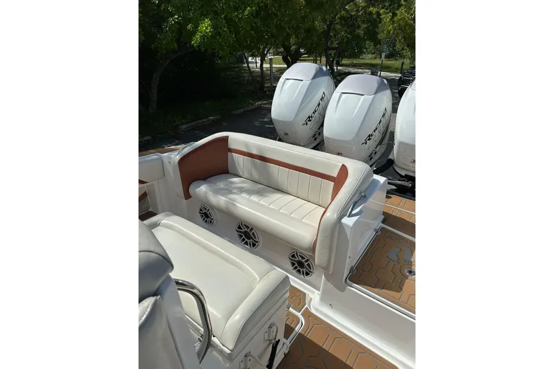 Slide: The Image of 2015 Nor-Tech 390 Sport Center Console with cushioned seating and powerful outboard engines. - 21