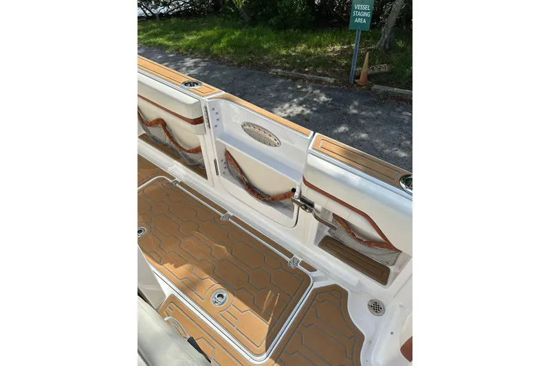 Slide: The Image of 2015 Nor-Tech 390 Sport Center Console interior with teak flooring and storage compartments. - 23