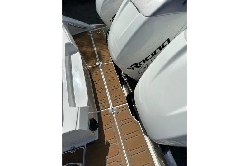 Slide: The Image of 2015 Nor-Tech 390 Sport Center Console with powerful outboard engines and sleek deck design. - 24