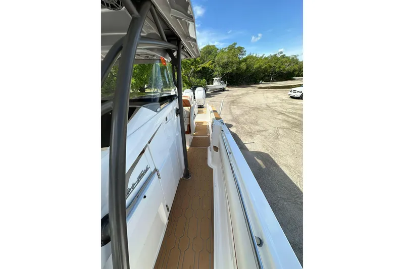 Slide: The Image of 2015 Nor-Tech 390 Sport Center Console boat, side view, docked on a sunny day. - 25