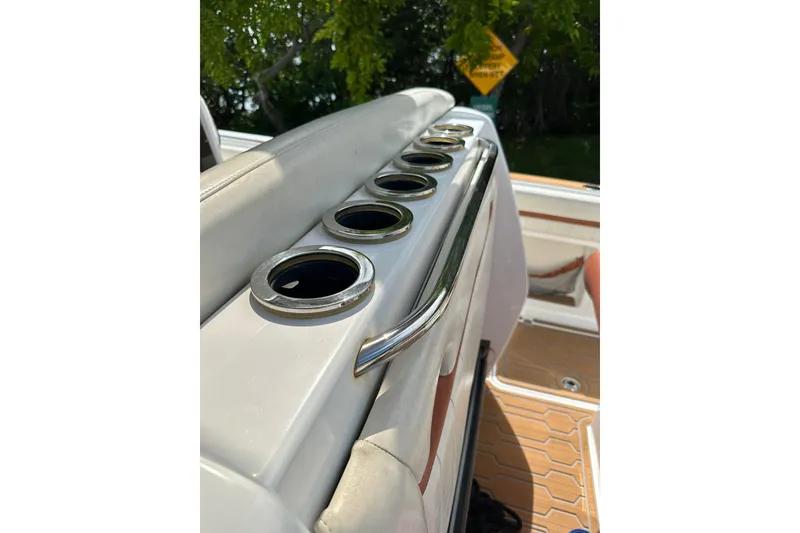 Slide: The Image of 2015 Nor-Tech 390 Sport Center Console boat interior with cup holders and seating. - 26