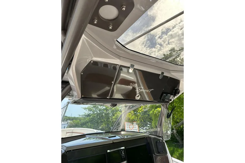 Slide: The Image of 2015 Nor-Tech 390 Sport Center Console interior with overhead console and clear canopy. - 27