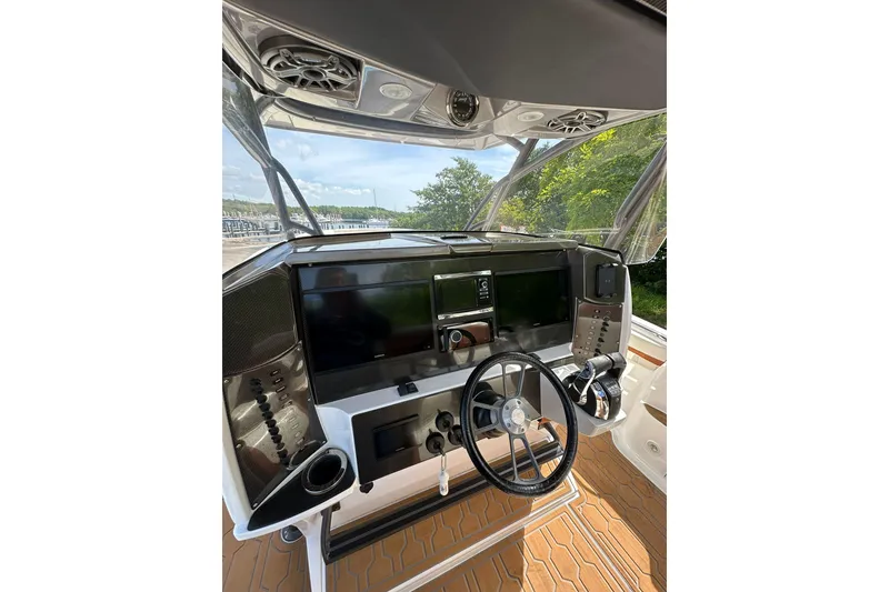 Slide: The Image of 2015 Nor-Tech 390 Sport Center Console dashboard with steering wheel and navigation controls. - 6