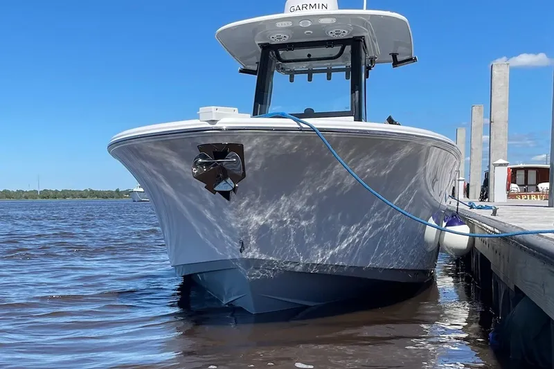 Slide: The Image of 2024 Sportsman Open 232 Center Console boat docked on a sunny day. - 10
