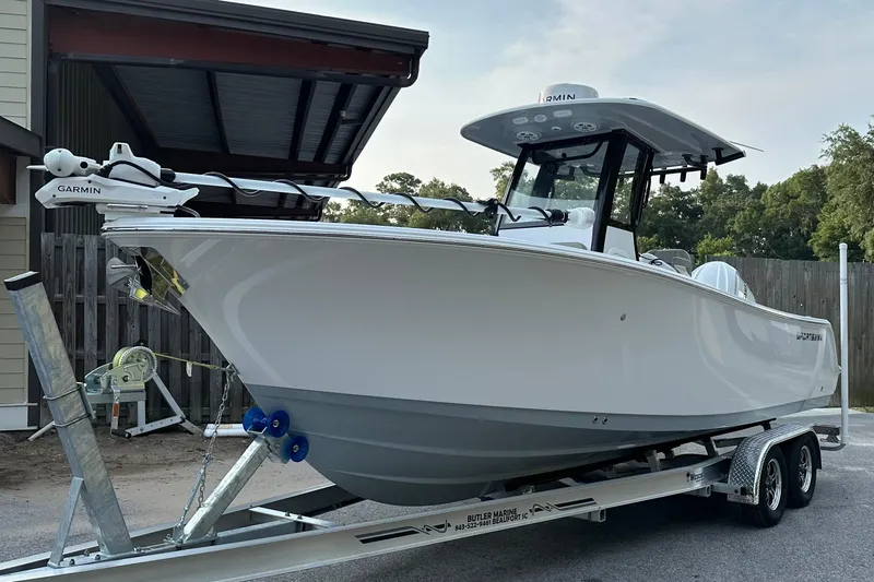 Slide: The Image of 2024 Sportsman Open 232 Center Console boat on trailer, featuring Garmin equipment. - 11